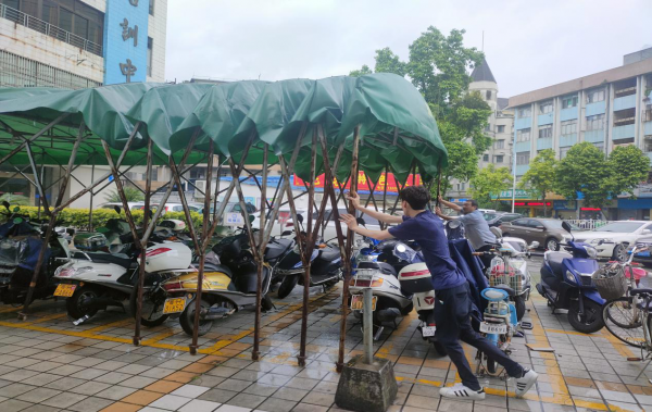 圖為員工正在拆除臨時搭建的遮陽棚.png